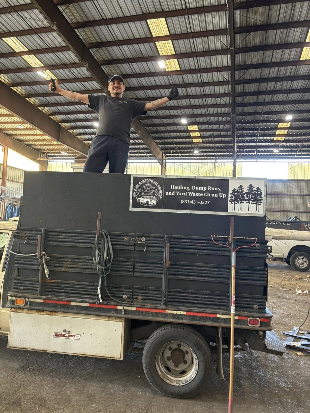 SLV Junk and Yard Waste Removal team member beside the hauling truck