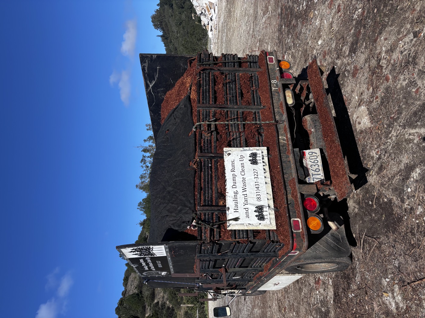 After view of the hauling truck fully loaded and secured with mulch